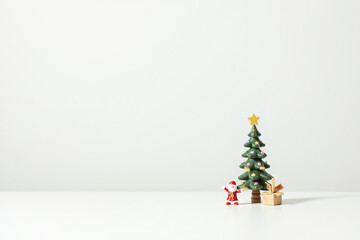 Christmas tree with winter holiday toys on white background in scandi style