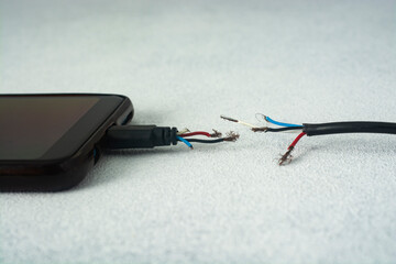 Close-up of broken smartphone charger cable.