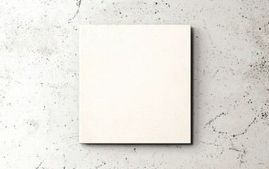 Blank canvas on a textured concrete surface ready for artistic expression and creativity in a modern workspace setting