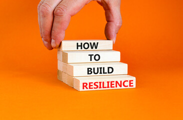 How to build resilience symbol. Concept words How to build resilience on beautiful wooden blocks. Beautiful orange table orange background. Business and how to build resilience concept. Copy space.