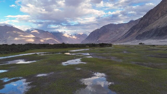 Aerial Drone shot of a greenland in ladakh with a river