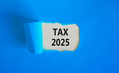 Planning tax 2025 new year symbol. Concept words Tax 2025 on beautiful white paper. Beautiful blue paper background. Business tax 2025 new year concept. Copy space.