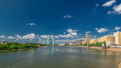 Obraz premium Yesil river timelapse hyperlapse with modern towers of residential complex in Astana
