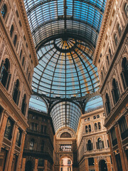 Naklejka premium Elegant Historic Arcade with Grand Glass Dome and Ornate Architecture