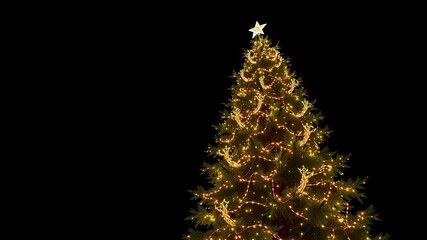 Obraz premium A majestic Christmas tree stands tall against a dark background, its branches adorned with twinkling lights that seem to dance in the air, sparkling ornaments, towering presence, dark room