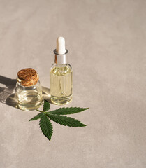 CBD oil hemp products. glass bottle with CBD oil, hemp leaves. Medicinal cannabis with extract oil. Cosmetics CBD oil
