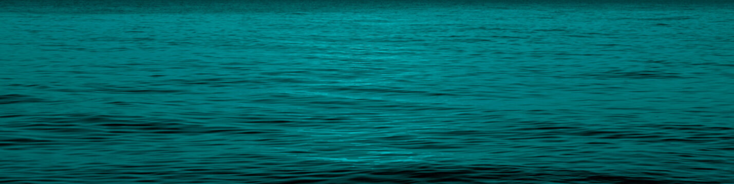 Blue Ripples Reflecting Sunset on surface texture pattern of aqua, Water. vibrant ocean scene at sunset capturing the warm glow of  sun over rippling water and the gentle transition evening to night