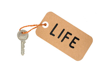 Key to Life Concept Idea Metaphor Text on Brown Paper Label with Door Key Isolated on White Background