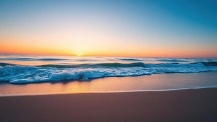 Fototapeta premium A soft blue ocean wave breaks on the shore of a tranquil fine sandy beach at sunset, creating a beautiful and serene scene, calm sea, natural beauty, shoreline