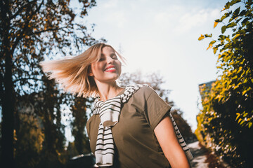 Photo of pretty young blonde woman fluttering hair cheerful smile wear khaki clothes tied shoulders...