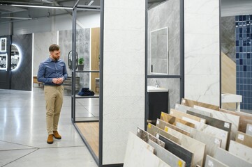 Choosing bath. Man in the store of goods for the home