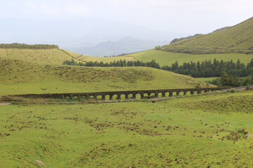 Aqueduct crossing through Sao Miguel island green hills