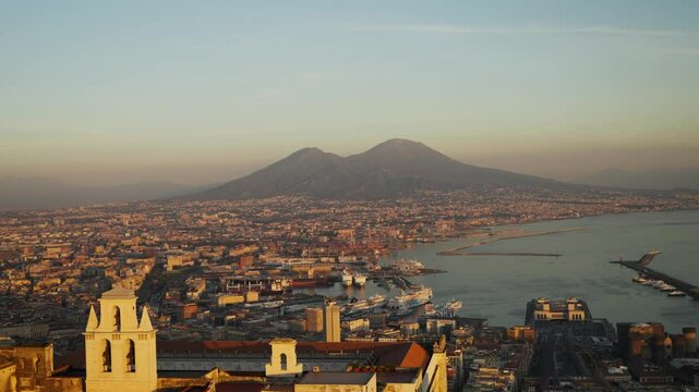 Naples at sunset, aerial view of Italian city of Naples and gulf of Naples, vacations in southern Italy, famous European tourist destination. 
