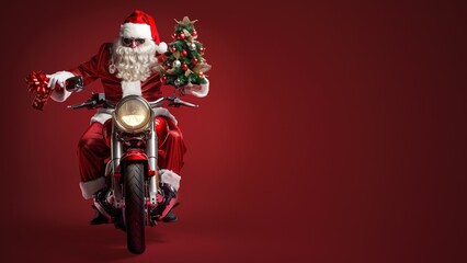Fototapeta premium Dressed in his iconic red attire, Santa happily rides a shiny motorcycle, accompanied by a small decorated Christmas tree, set against a lively red background.
