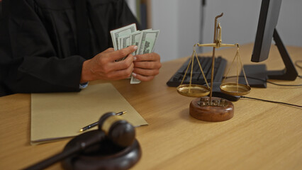 Judge in office counting american dollars sitting near scales of justice and gavel on desk