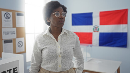 Woman standing in an electoral room with dominican republic flag in the background, showcasing...