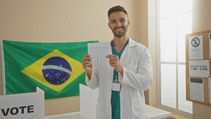 Handsome young hispanic man with a beard holds a voting envelope at an indoor brazilian electoral...