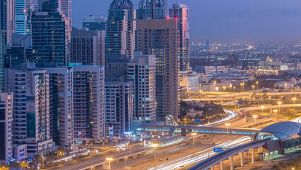 Dubai Marina skyscrapers aerial top view before sunrise from JLT in Dubai night to day timelapse, UAE.