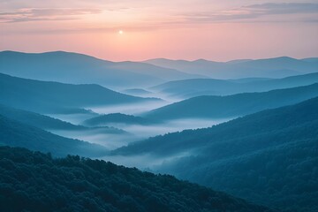 Fototapeta premium Beautiful sunrise over misty mountain valleys in early morning light