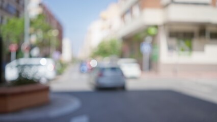 Blurred background of an urban street scene with cars and buildings in a sunlit cityscape