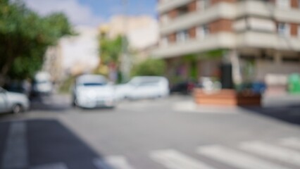 Blurred image of a city street with vehicles and buildings in the blurred background with a shallow depth of field.