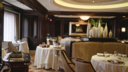 Blurred luxurious restaurant interior with elegant table settings, dim lighting, and sophisticated decor, emphasizing a refined and exclusive dining atmosphere.