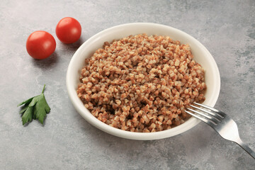 Buckwheat on a white plate - food photography.  Russian food. Close up.