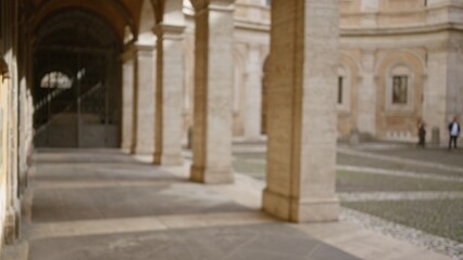 Blurred view of an old university campus outdoors with a focus on historic architecture and defocused background, creating a serene educational environment, no identifiable people visible.
