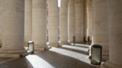 Blurred view of sunlit columns casting shadows in vatican city, italy, highlighting architectural...
