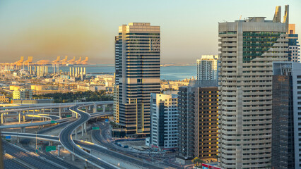 Dubai Marina skyscrapers aerial top view at sunrise from JLT in Dubai timelapse, UAE.