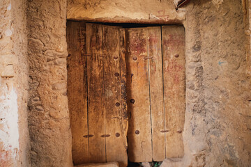 Rustic Ancient Wooden Door in Stone Wall