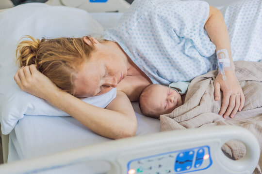 A baby lies with the mother after childbirth, resting peacefully. The serene moment captures the bond between mother and child as they begin their journey together. The hospital environment ensures a