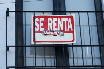 Old weathered sign in Spanish apartment for rent on the window of a condo in a small tourist town. Puerto Vallarta, Jalisco, Mexico. Rental market, vacation property concept.