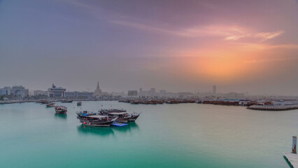 Sunset at Doha Bay timelapse with Traditional Wooden Dhow Fishing Boats.