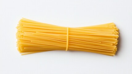 A bundle of uncooked spaghetti, tightly bound with a rubber band, showcasing its long, slender shape and vibrant yellow color.