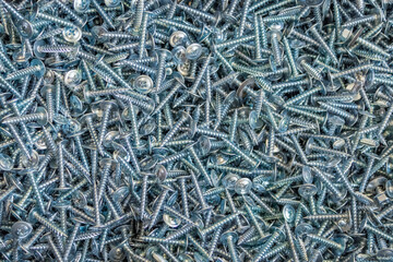 zinc-coated cross head screws. Industrial texture for the background