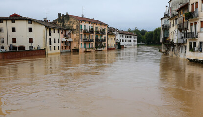 houses submerged by brown muddy water during river flood and overflow