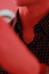 zoom out of a man's neck wearing blue shirt