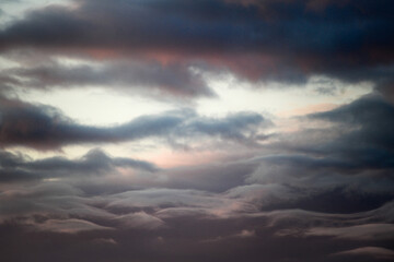 The bright sun is shining beautifully through the clouds in the sky above