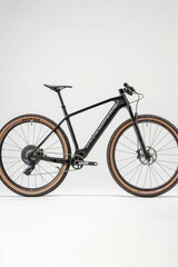 Black mountain bike with tan tires.