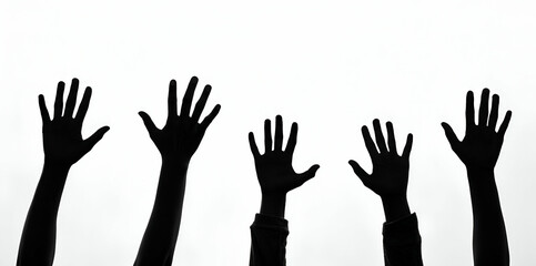 Fototapeta premium A silhouette of hands raised against a white background, symbolizing unity, support, or a call for attention.