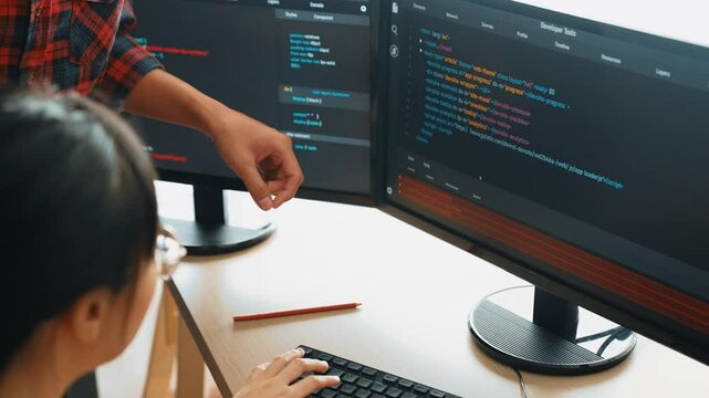 Slow motion back end or software developer manager supervising his team on new application program development on debugging and solving complex code algorithms on monitor. Burgeoning