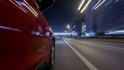 Naklejka premium Drivelapse urban look from fast driving car at a night avenue in a city timelapse hyperlapse