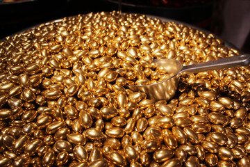Sale by weight of golden chocolate candies