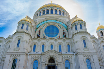 Grand cathedral with golden domes and ornate facade on a sunny day