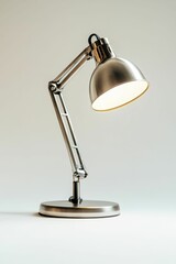 Silver desk lamp with a white shade.