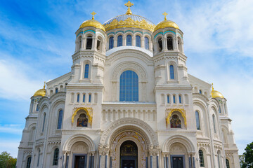 Grand cathedral with golden domes and ornate facade on a sunny day
