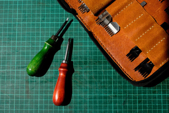 Leather craft tools on cutting mat for detail work