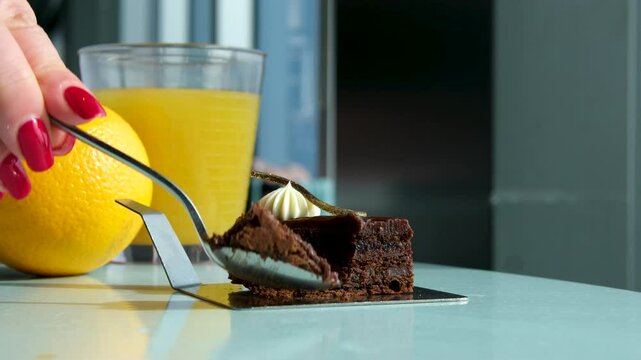 chocolate cake with orange Cutting a chocolate cheesecake with a knife sliced orange