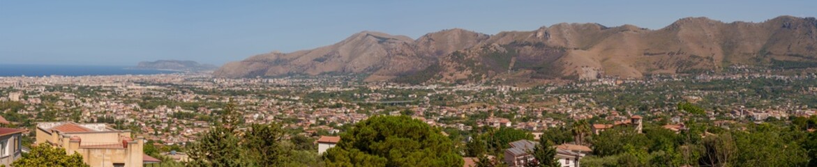 Obraz premium Panoramic view of Palermo city and mountains from Monreale town, Sicily, Italy, vast coastal cityscape framed by mountains in the background, coastline and urban landscape